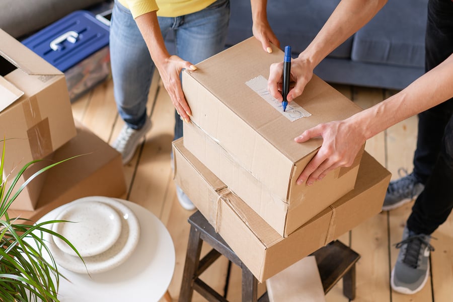 bigstock Close Up Of Hand Packing Cardb 314637226
